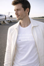 Relaxed lifestyle shot of man wearing was on the edge yesterday kinda liked it near a private jet.