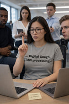 Overwhelmed woman at a desk wearing digital cough still processing shirt navigating the modern world.