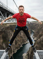 Risk and reward: man in THE VIEW CHANGES WHEN YOU DARE. red tee; great gift for an adventurer or a traveler who loves pushing boundaries