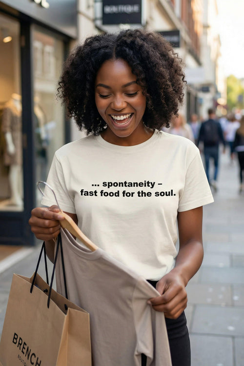 Smiling woman holding a bag wearing spontaneity fast food for the soul letting days unfold, perfect gift.