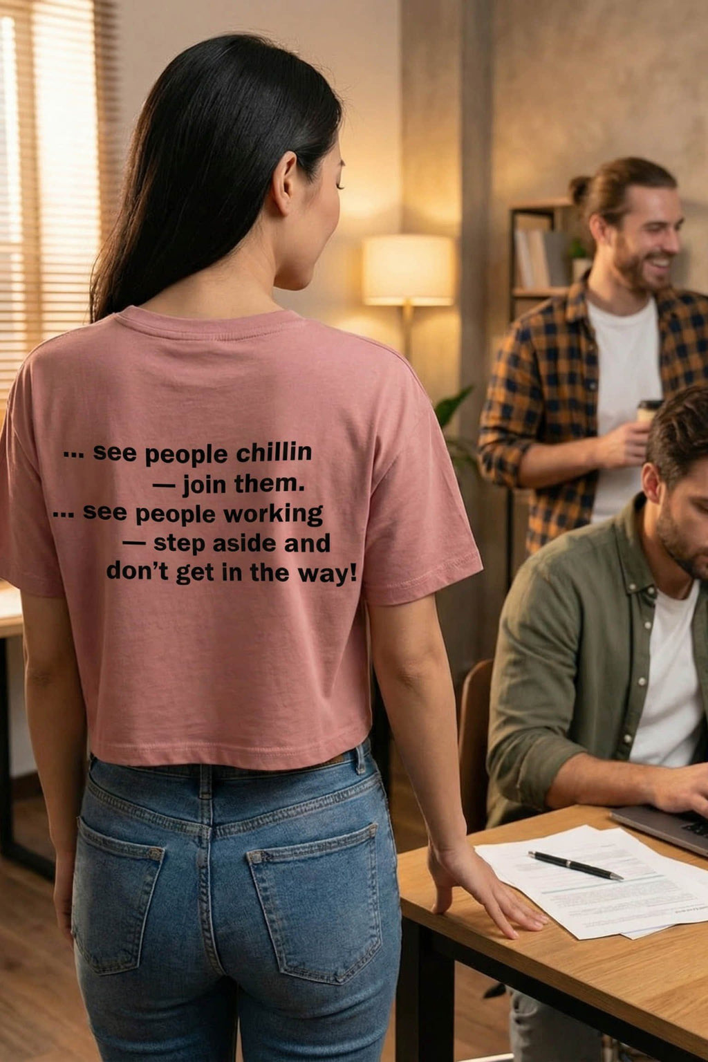 Woman standing in an office wearing see people working step aside creating effortless harmony, ideal coworker gift.