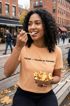 Happy woman enjoying outdoor food wearing thanks to Canada celebrating northern hospitality, perfect gift for travelers.
