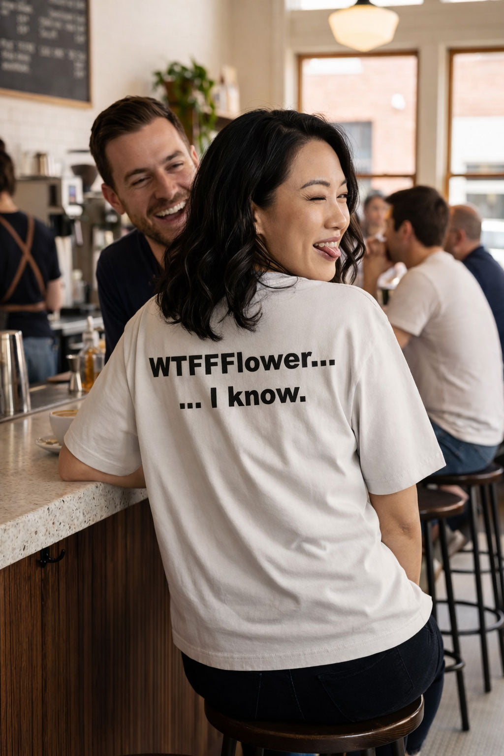 Laughing woman at a coffee shop wearing the WTFFFlower I know shirt making a perfect bold gift.