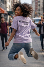 Energetic woman jumping on a city street in her WTFFFlower I know tee celebrating bold unique energy.
