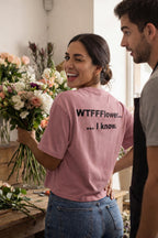 Smiling woman holding a large bouquet wearing the WTFFFlower I know shirt ideal for a sarcastic friend.