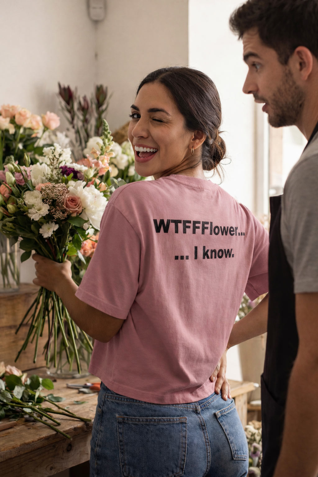 Smiling woman holding a large bouquet wearing the WTFFFlower I know shirt ideal for a sarcastic friend.