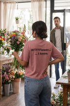 Confident woman walking into a shop in the WTFFFlower I know tee embracing a liberating self-awareness.