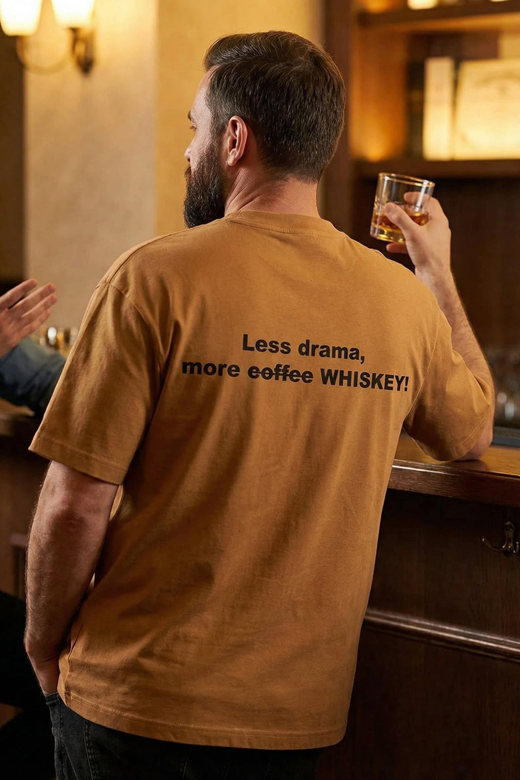 Relaxed man at a bar wearing less drama more coffee whiskey enjoying the present moment, perfect gift.