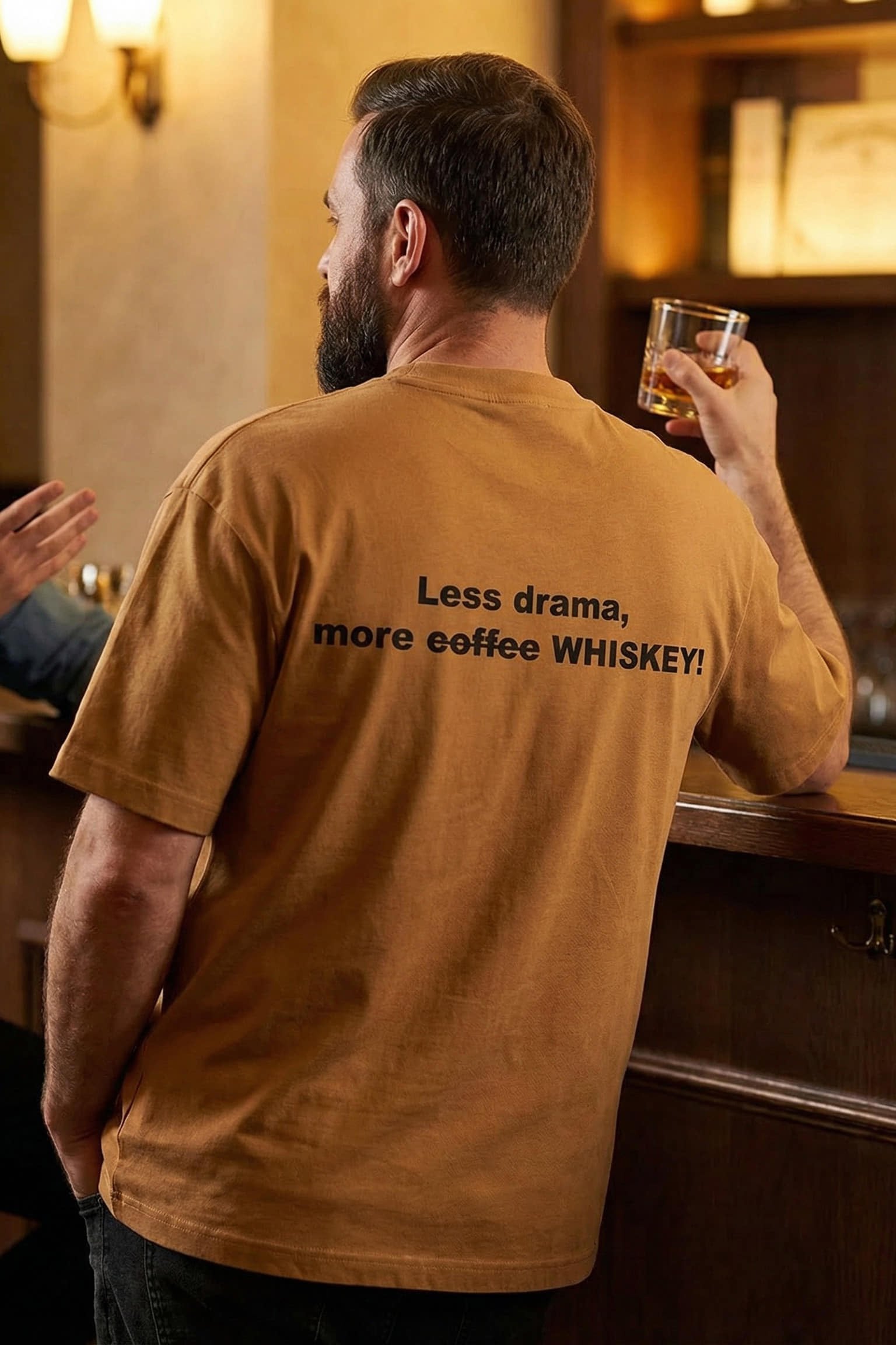 Relaxed man at a bar wearing less drama more coffee whiskey enjoying the present moment, perfect gift.