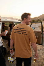Smiling man by a car wearing alcohol isn't gasoline leaving the hustle behind, ideal travel gift.