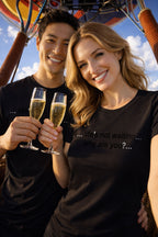 Happy couple wearing life's not waiting why are you embracing the present moment on a hot air balloon.