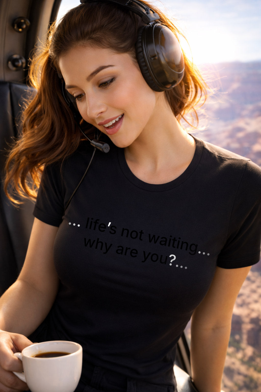 Adventurous woman wearing life's not waiting why are you turning dreams into reality during a helicopter flight.