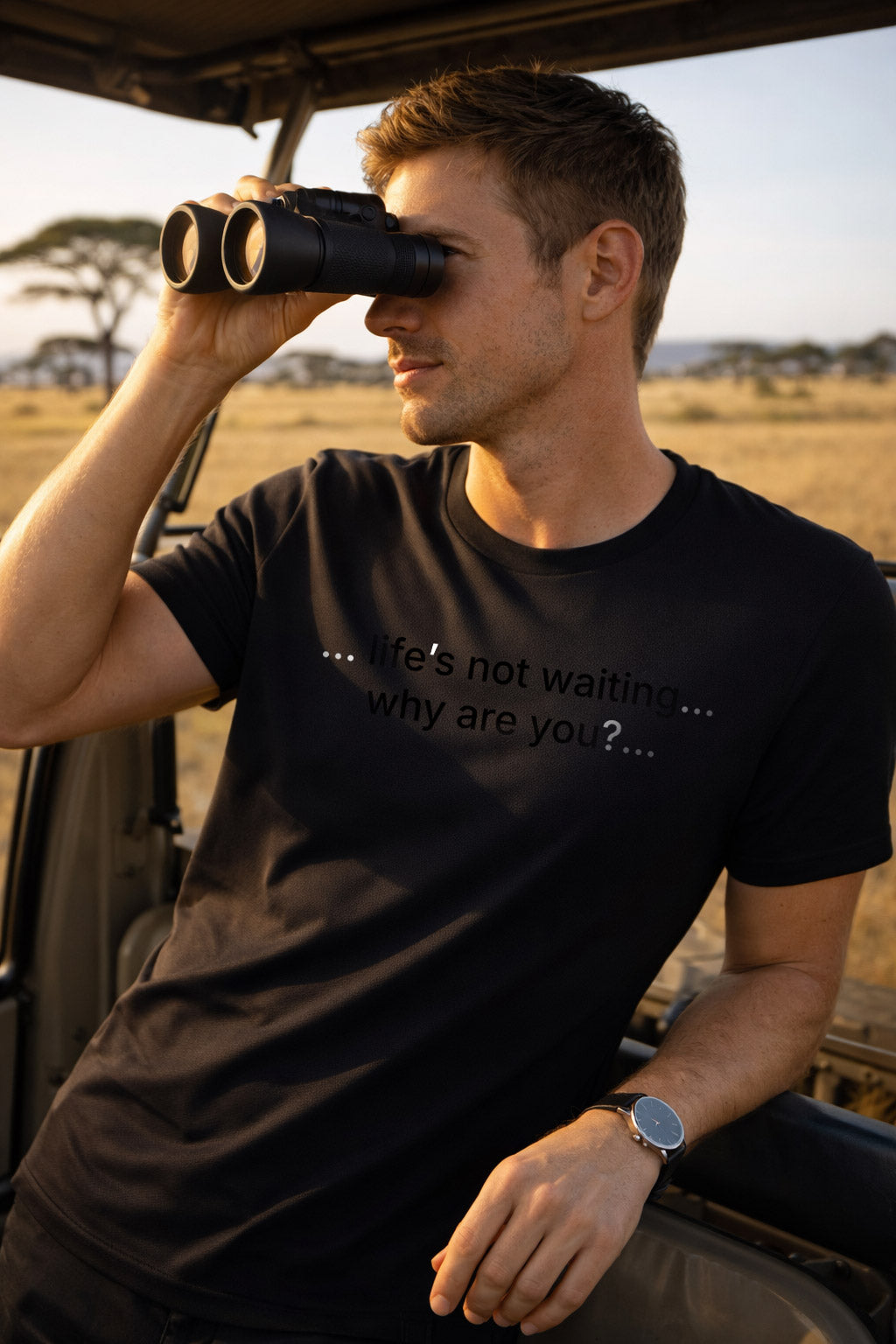 Confident man wearing life's not waiting why are you making bold choices on a sunny safari adventure.