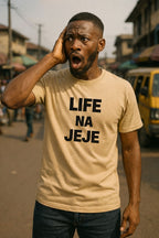 Surprised young man touch head wear life na jeje shirt because rushing no dey solve problem today.