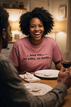 Laughing woman at dinner wearing the kiss me no edits no limits tee a meaningful partner gift.