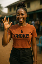 Smiling woman raise hand wear e choke shirt as heavy impact of success dey surprise everybody today.