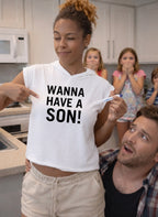 Exciting pregnancy announcement: woman in WANNA HAVE A SON! shirt with a positive test; a perfect creative gift for a husband or partner