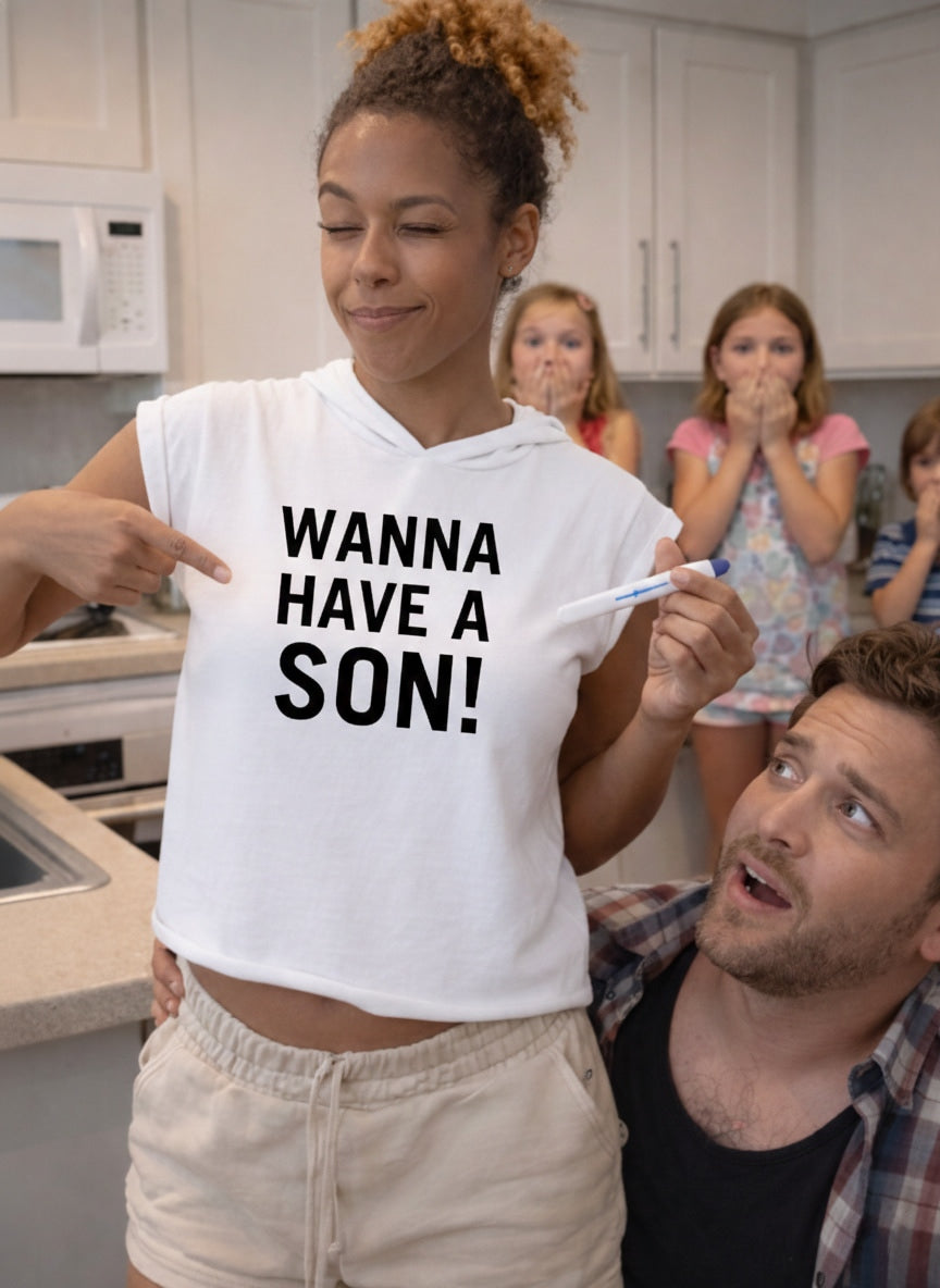Exciting pregnancy announcement: woman in WANNA HAVE A SON! shirt with a positive test; a perfect creative gift for a husband or partner