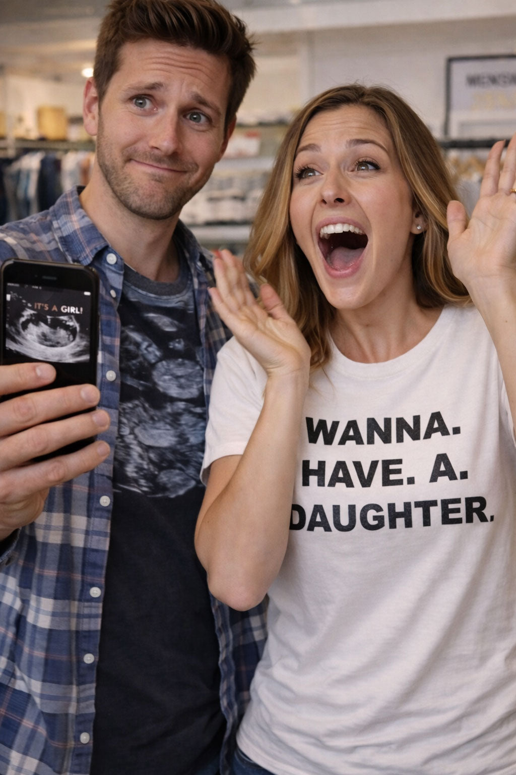 Excited couple celebrating good news wearing wanna have a daughter shirt hoping for a different family energy.