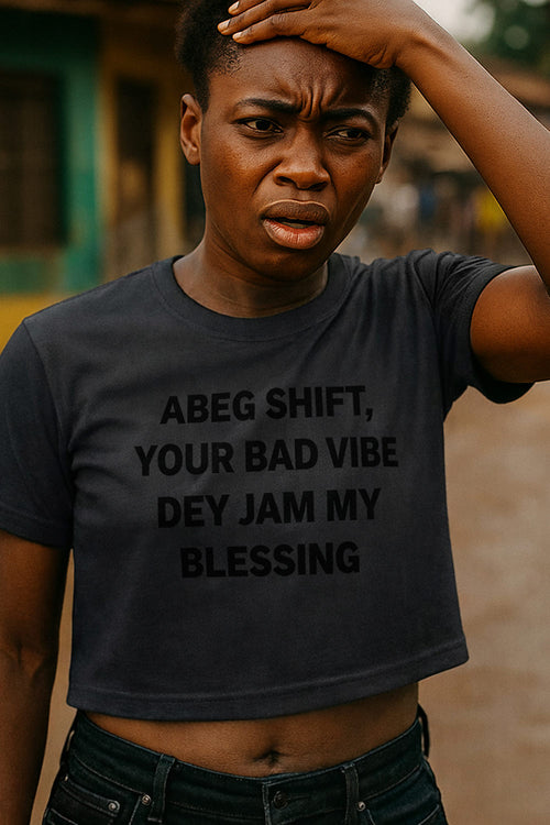 Stressed woman touch head wear abeg shift your bad vibe dey jam my blessing crop top.
