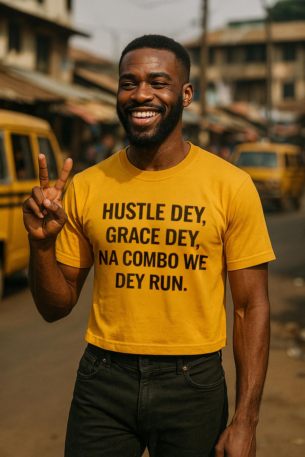 Smiling man show peace wear hustle dey grace dey na combo we dey run shirt as gift.