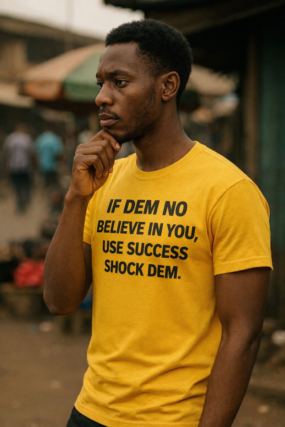 Thoughtful guy touch chin wear if dem no believe in you use success shock dem tee gently.