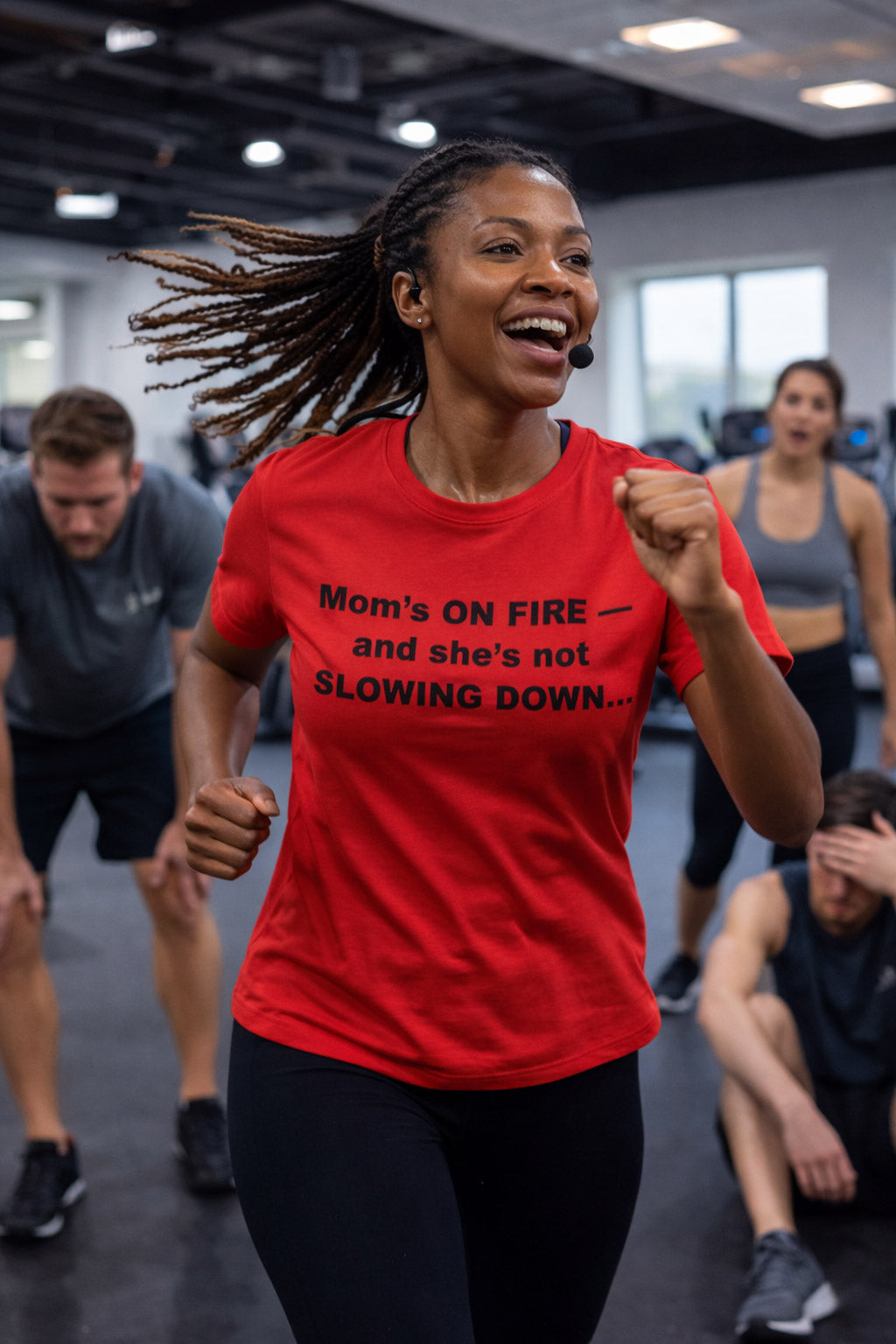 Confident mother running in a gym wearing mom's on fire and she's not slowing down tee for parents.