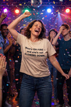 Joyful woman dancing under lights wearing mom's on fire and she's not slowing down shirt ideal for friends.