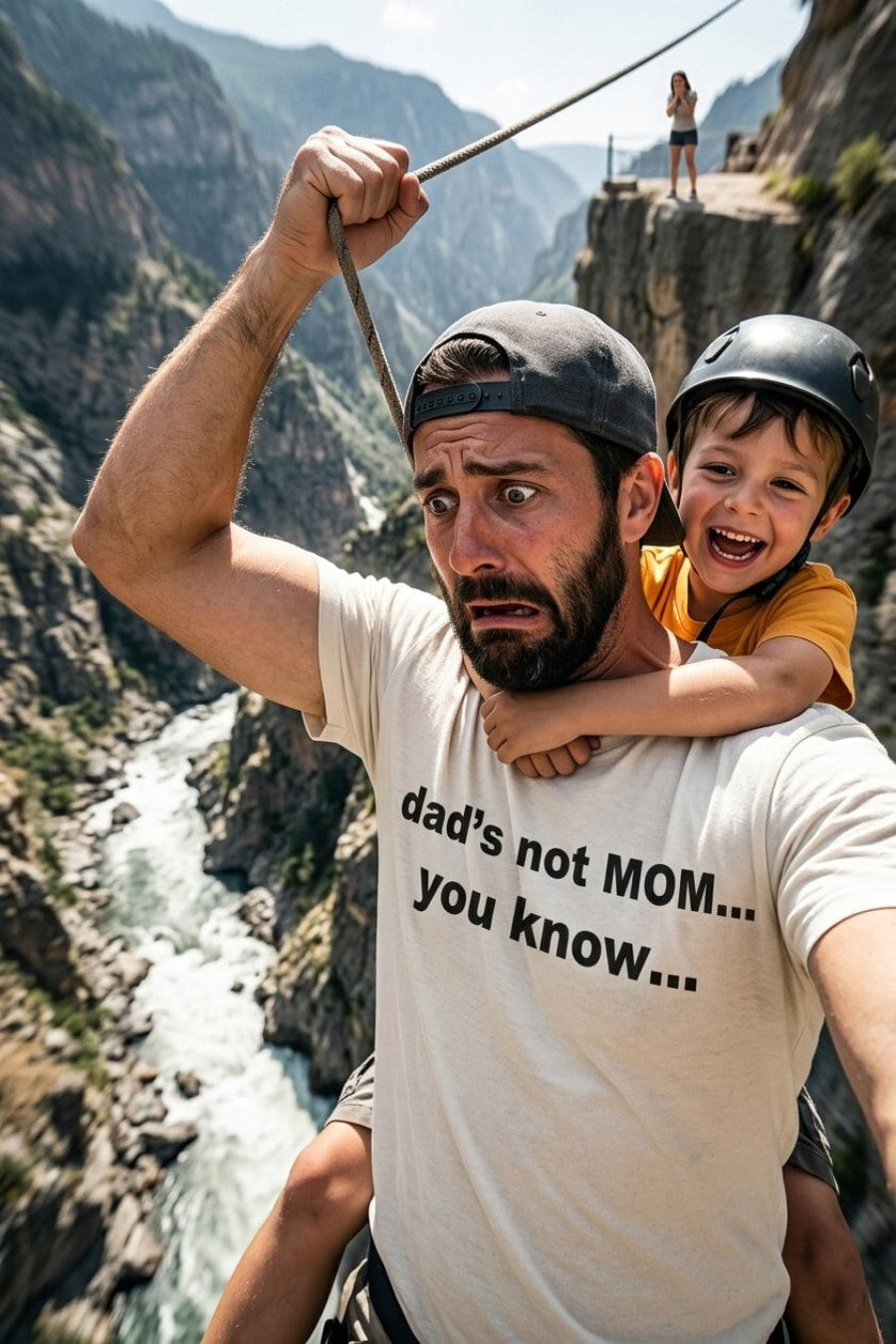 Adventurous father holding a child on a cliff wearing dad's not mom you know, perfect dad gift.