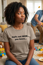 Amused mother resting in a messy room wearing dad's not mom you know, perfect gift for parents.