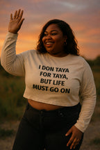 Smiling woman waving hand in I don taya for taya but life must go on strong spirit gift.