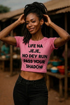 Smiling woman touching hair in life na jeje no dey run pass your shadow steady pace gift.