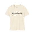 Minimalist flat lay of Stay scared. Do it anyway! premium cream shirt; high-quality fabric detail for a luxury motivational gift