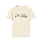 Minimalist flat lay of Stay scared. Do it anyway! premium cream shirt; high-quality fabric detail for a luxury motivational gift