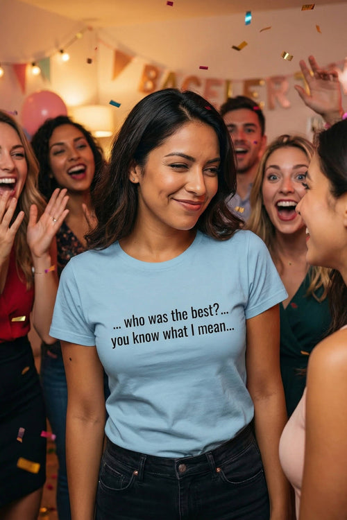 Smiling woman at a lively party wearing who was the best you know what I mean, perfect gift.