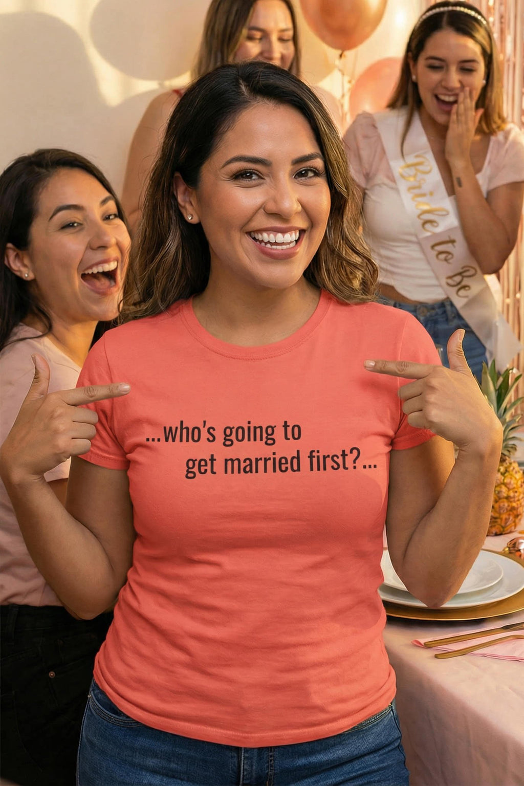 Laughing woman pointing to herself wearing who's going to get married first celebrating friendship, ideal bridesmaid gift.