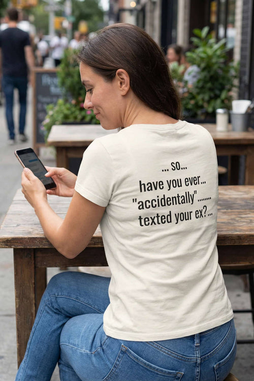 Smiling woman outdoors with phone wearing so have you ever accidentally texted your ex, ideal friend gift.