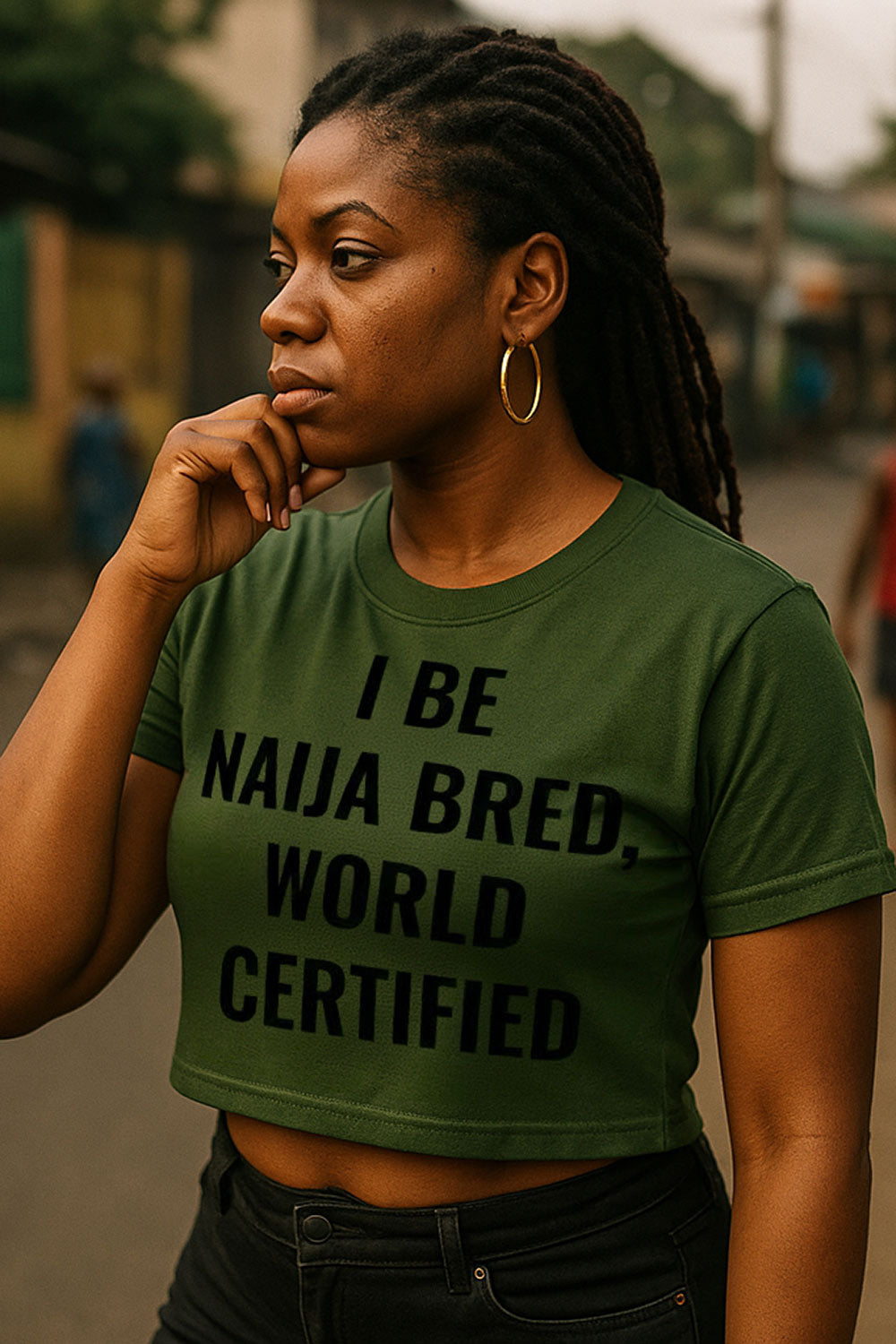 Thoughtful woman looking away wearing I be naija bred world certified proving pure talent meaningful gift.