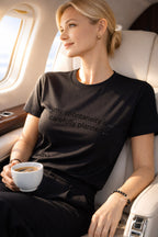 Relaxed person wearing my spontaneity is carefully planned in a plane, finding unique freedom in a secure foundation.