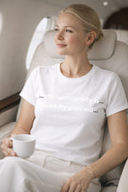 Relaxed person wearing my spontaneity is carefully planned while holding a cup, finding peace in their deliberate chaos.