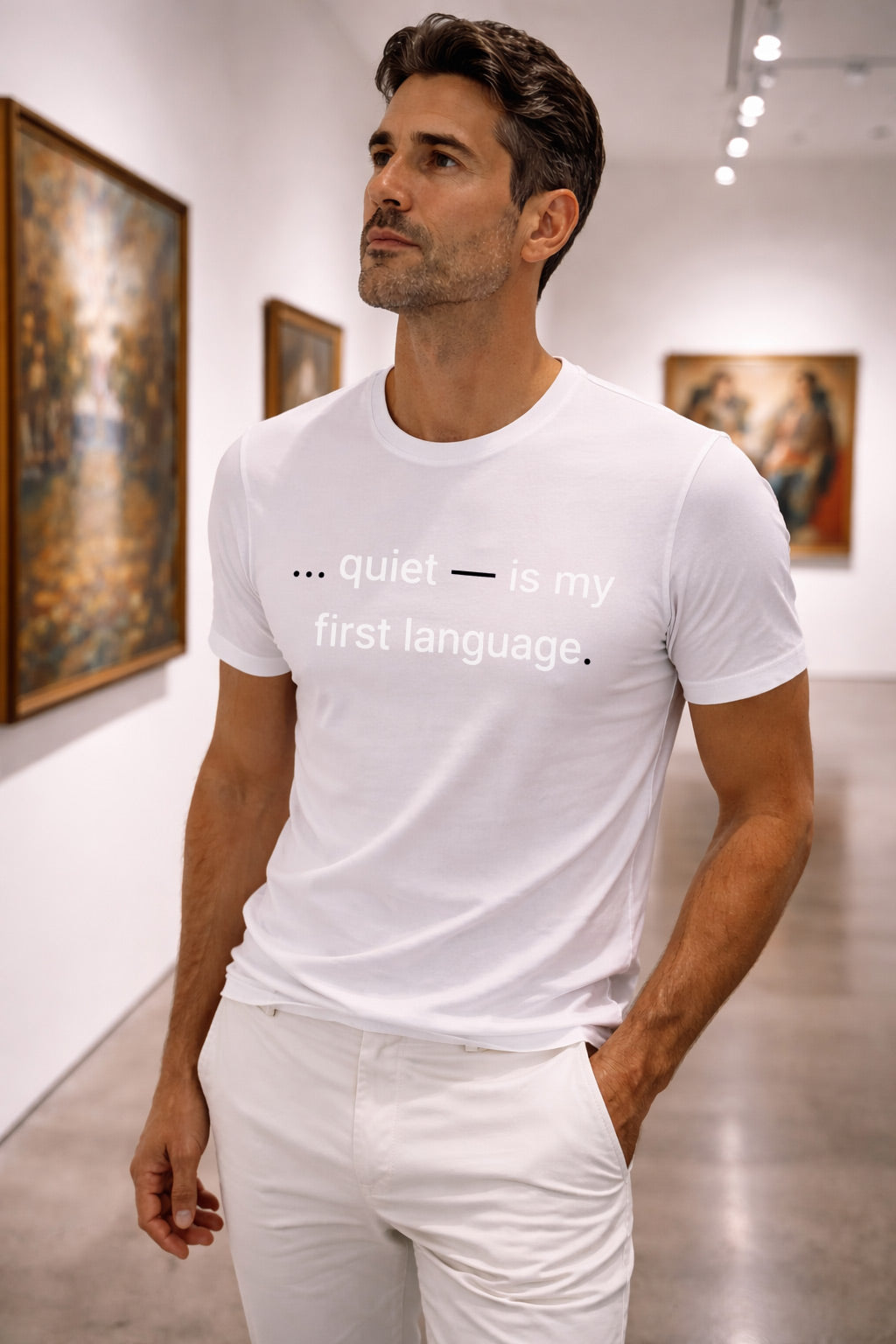 Confident man wearing quiet is my first language in a tranquil art gallery finding understanding in shared silent spaces.