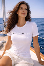 Relaxed woman wearing quiet is my first language finding profound peace and accepting self exactly as she is at sea.