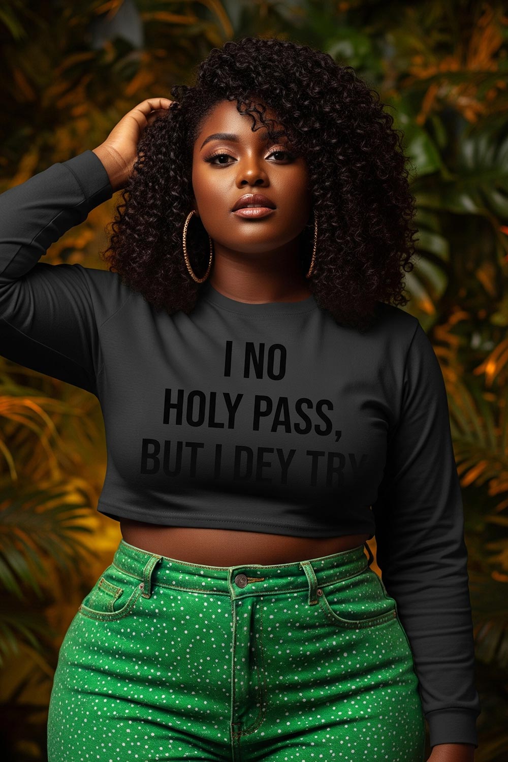 Relaxed woman touching hair wearing I no holy pass but I dey try correct character perfect gift.