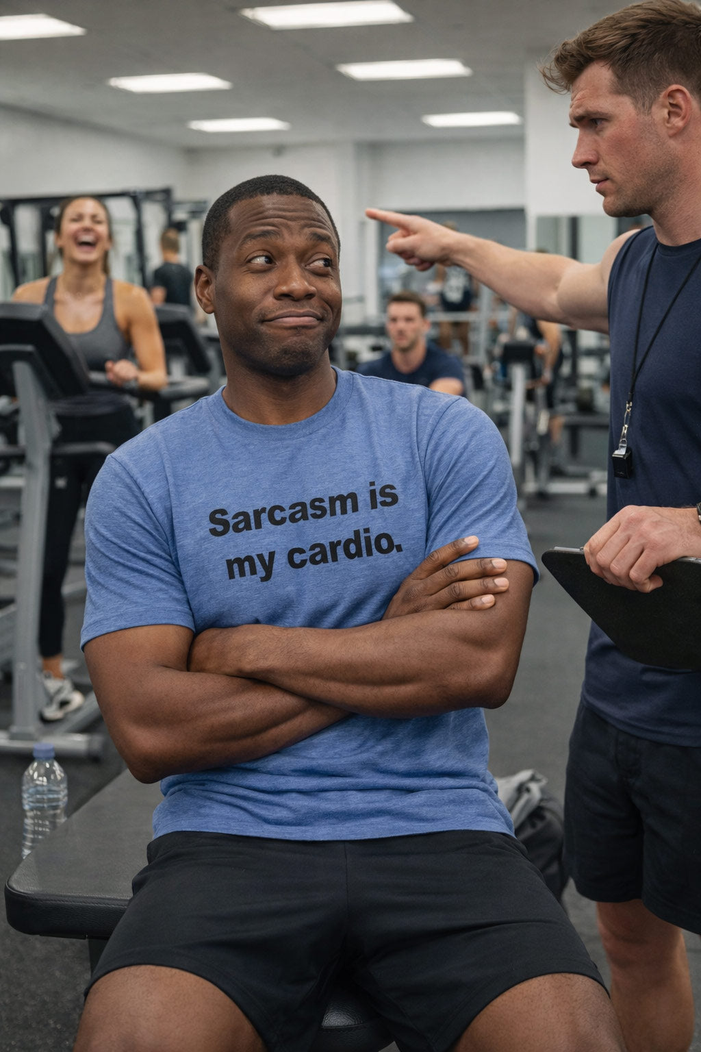 Smirking man at the gym wearing the sarcasm is my cardio shirt engaging in quick-witted banter.